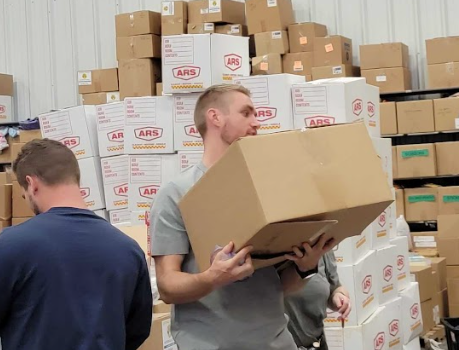 Organizing baby supply donations for refugees at Helping Hands International.