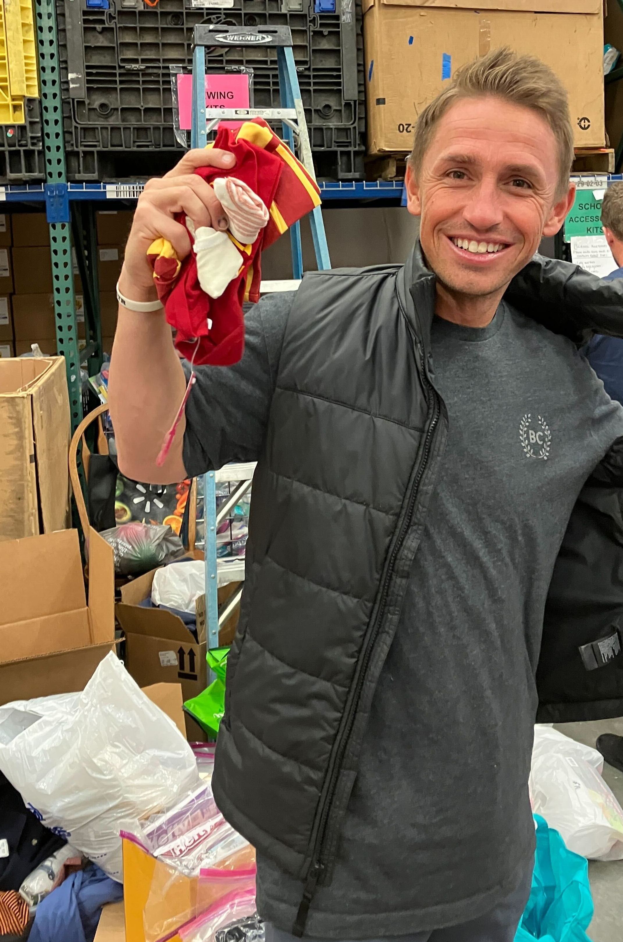 Sorting baby supplies for refugees at Lifting Hands International.