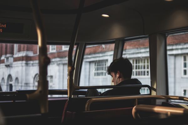 Man on bus listening to music