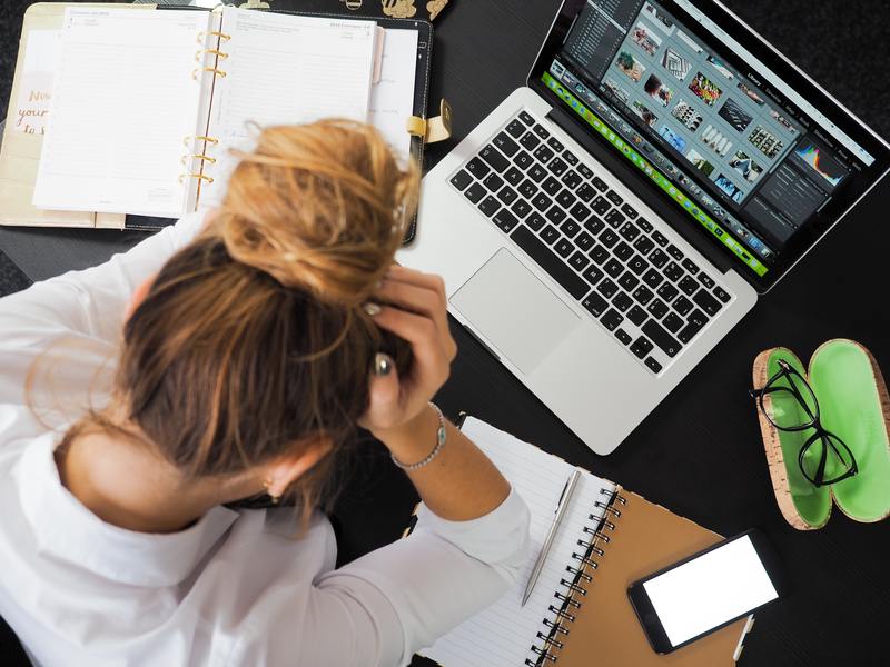 Woman stressed at laptop