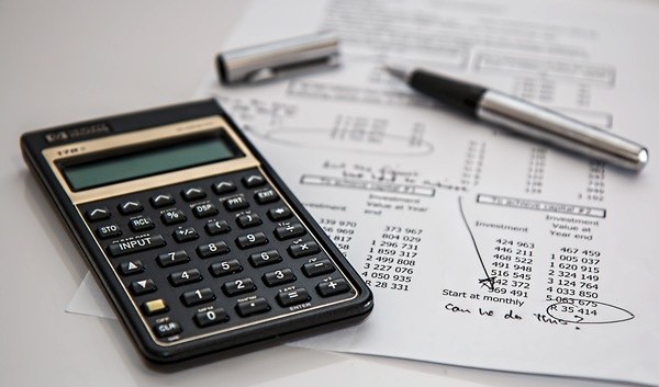 Calculator and financial documents on a desk