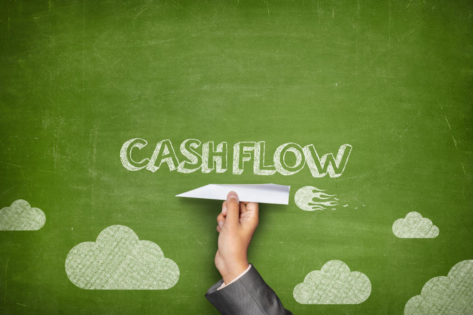 The word "cashflow" written in chalk on a green chalkboard