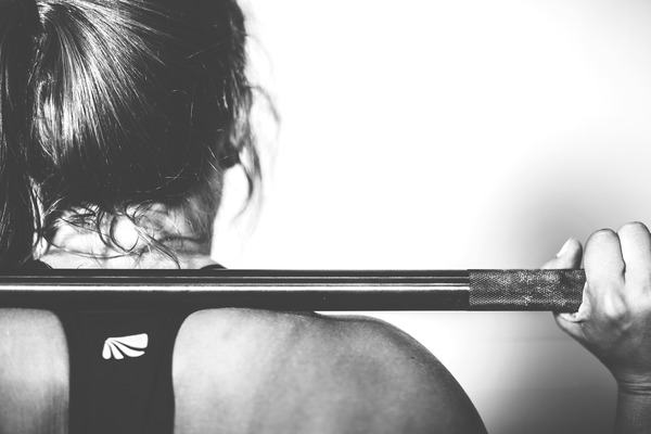 woman doing squats with weights