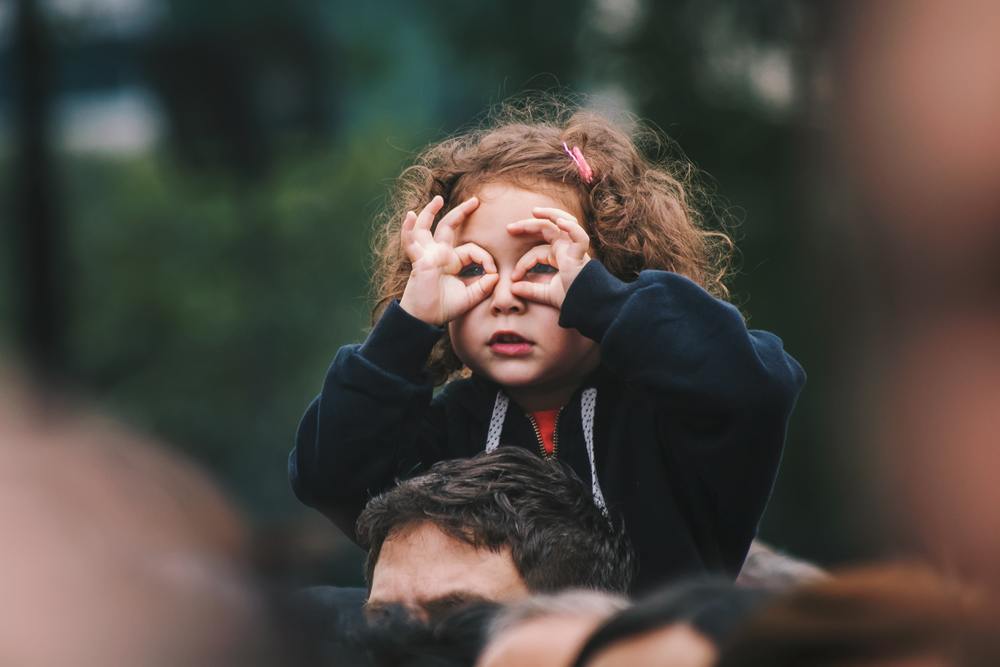 Girl on dad's shoulders