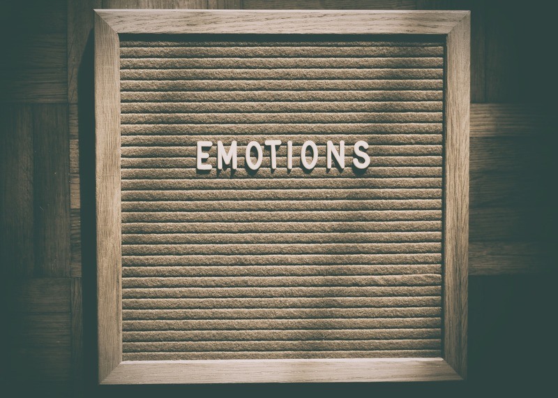 The word "emotions" spelled out on letter board