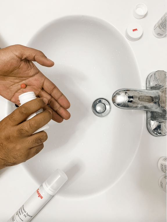 holding finasteride pill over sink