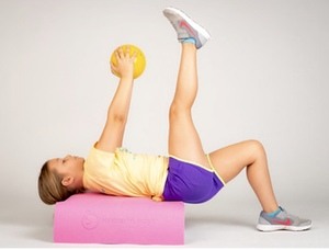 Little girl working out with workout ball