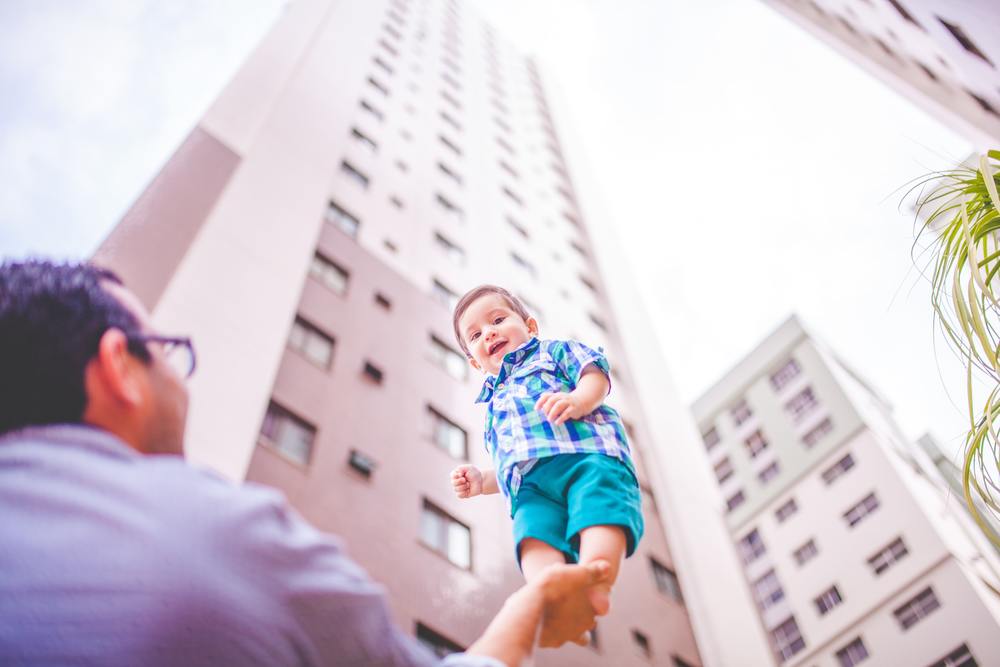 Dad holding up baby