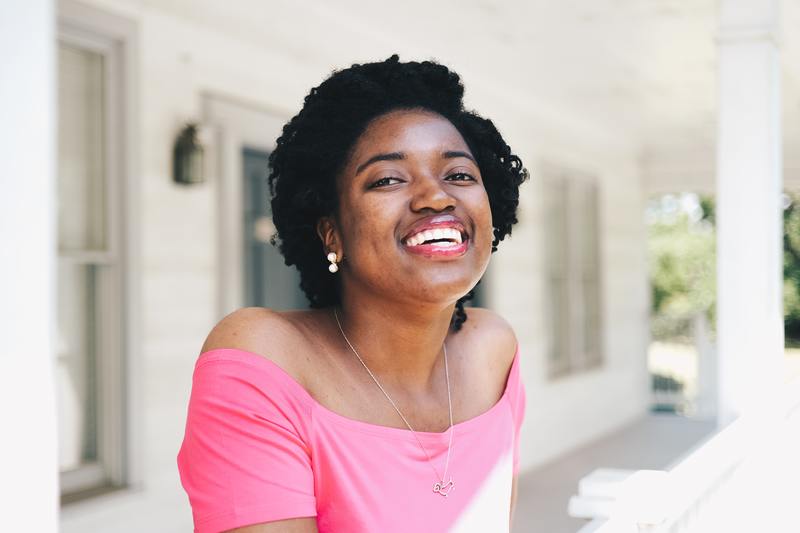 woman on a porch smiling